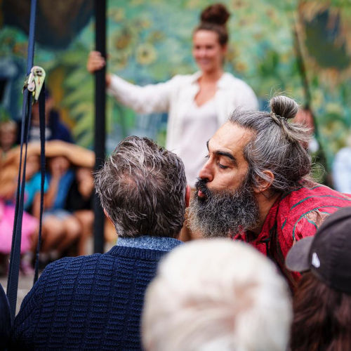 Playground - Chinese Pole Acrobatics Show. Miguel Rubio kissing a spectator on the cheek