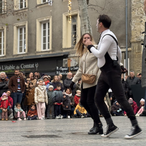 Agro the clown. ImproLocura. Agro dances with a spectator with a happy audience in the background at the street performance.Luca Della Gatta